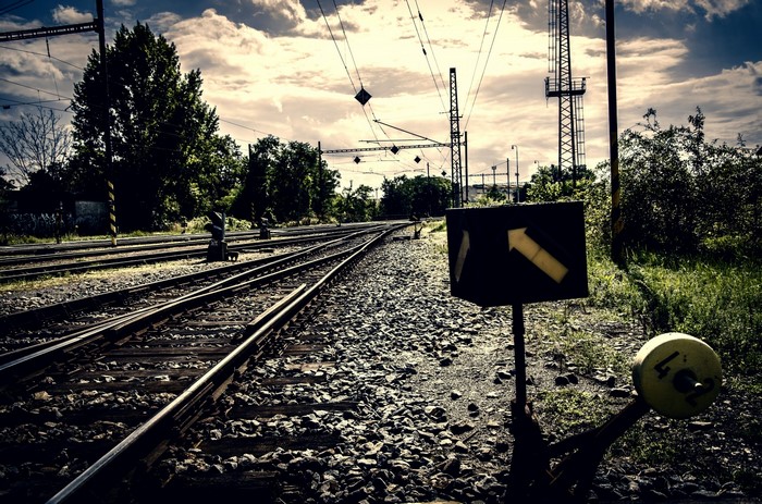 Train tracks with signal and overhead wires