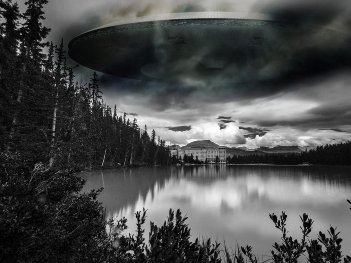 UFO hovering over a lake and hotel