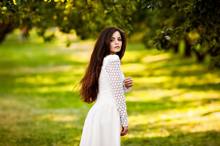 Woman in white dress in a park