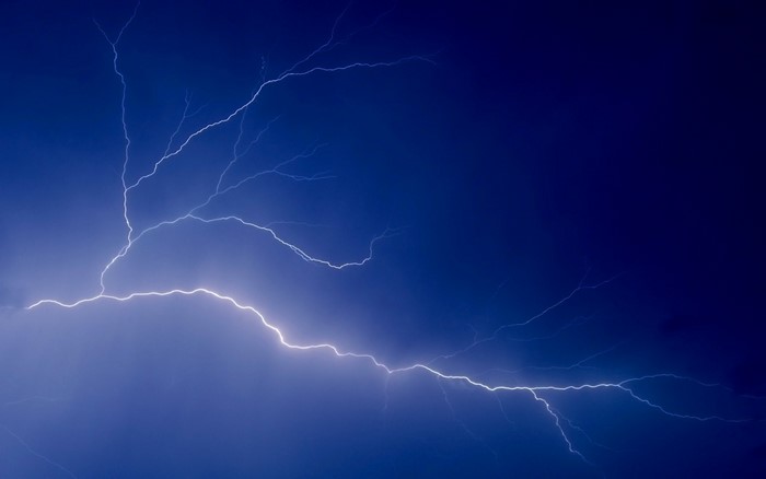 Lightning strike in a dark blue sky