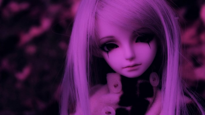 Close-up of a doll with purple lighting