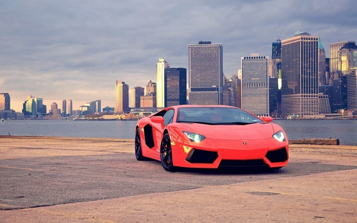 Red Lamborghini Aventador in front of New York City skyline