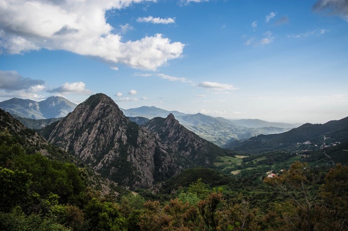 Mountainous landscape with rolling hills and clouds
