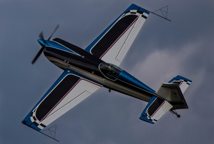 Aerobatic airplane in flight against a cloudy sky