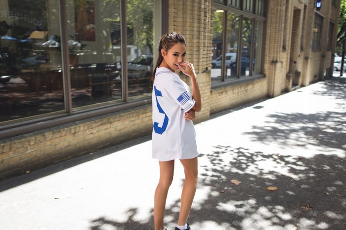 Woman in white jersey dress with blue number 5