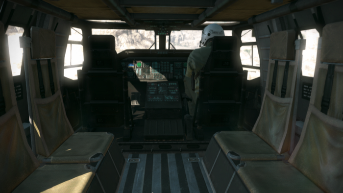 Interior of a military helicopter cockpit with pilot