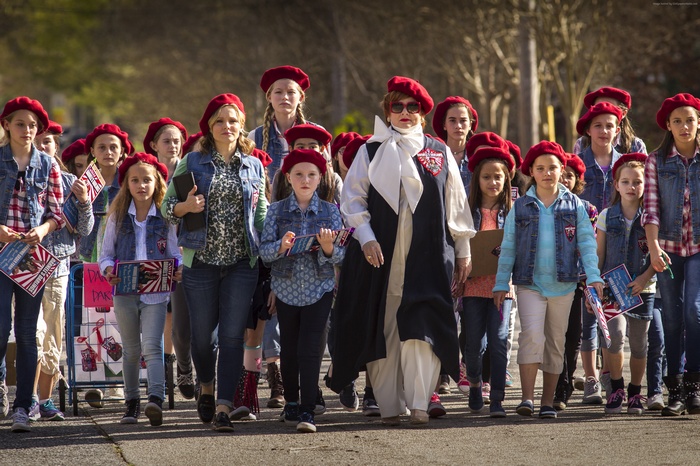 Melissa McCarthy and girls in red berets marching