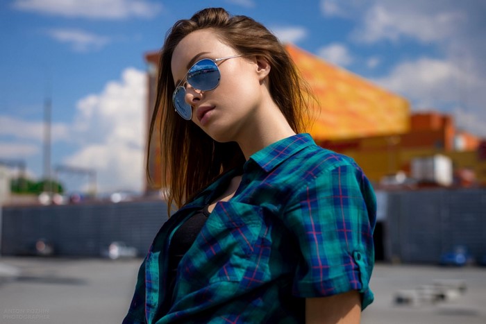 Woman with sunglasses and plaid shirt