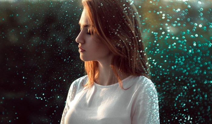 Woman with closed eyes and sparkles in hair