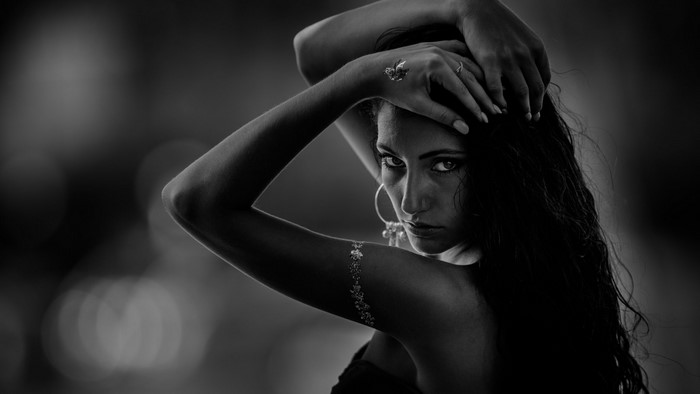 Monochrome portrait of a woman with arms up