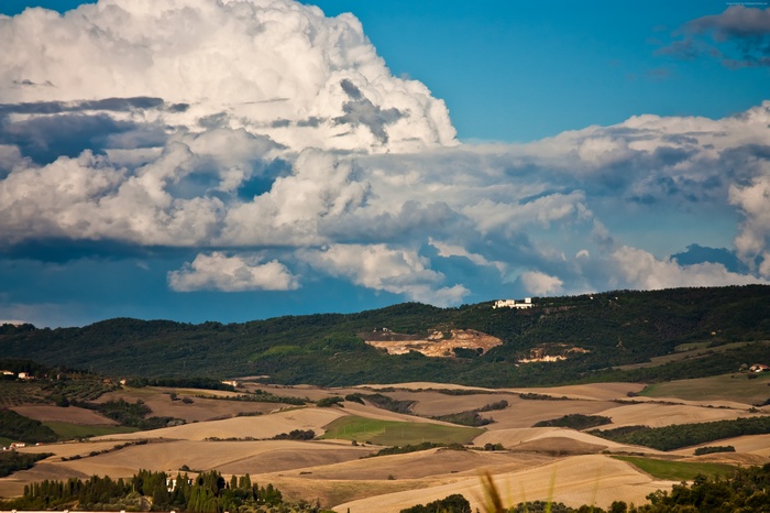 Toscana landscape with rolling hills and dramatic clouds