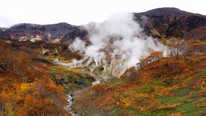 Valley with steaming geothermal vents in autumn