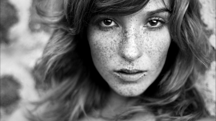 Monochrome portrait of a woman with freckles