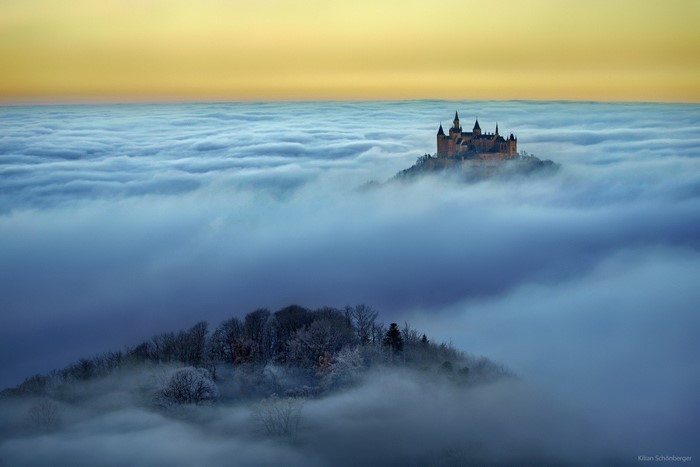 Castle above the clouds at sunrise
