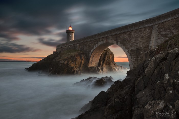 Lighthouse on Rocky Coast at Dusk
