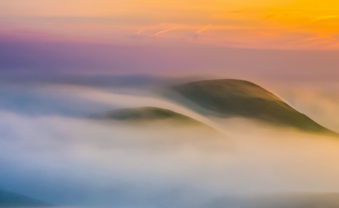 Misty mountains at sunrise with colorful sky