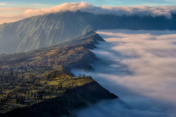 Mountain range covered in clouds at sunrise