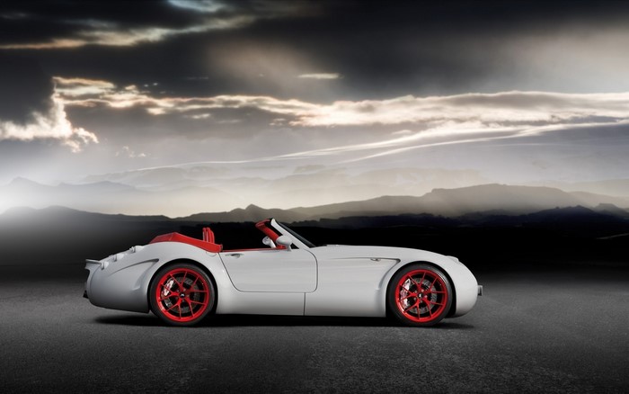 White Wiesmann GT Roadster with red accents on a road
