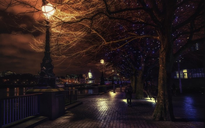 Nighttime London cityscape with streetlights and river