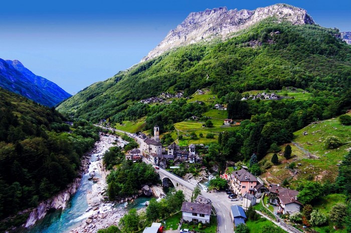 Village in a Mountain Valley with a River and Bridge