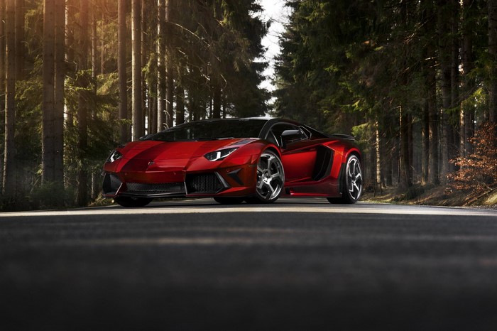 Red Lamborghini Aventador parked on a forest road
