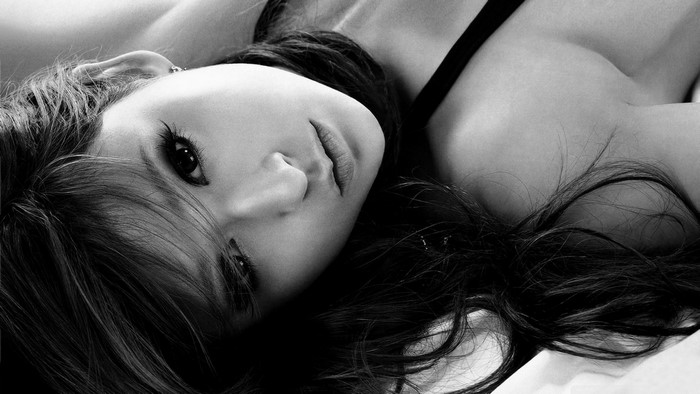 Monochrome portrait of a woman lying down