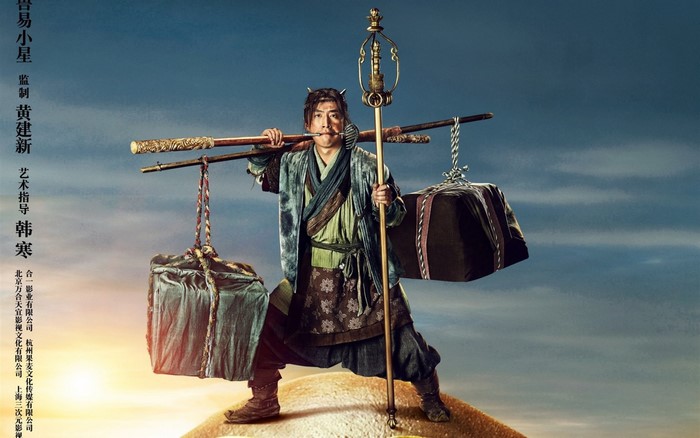 Man carrying burdens with a staff
