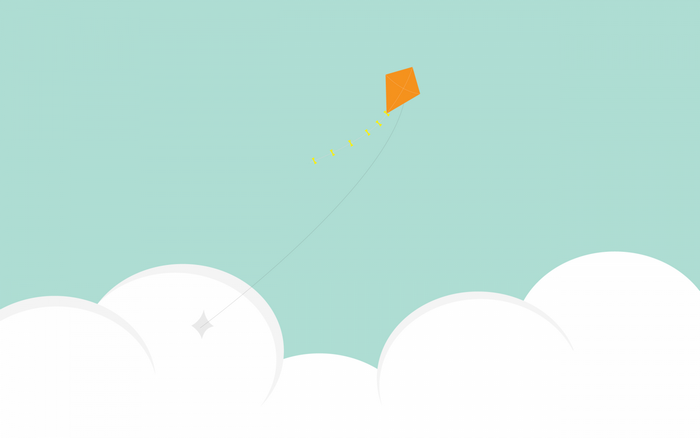 Orange kite flying in a blue sky with clouds