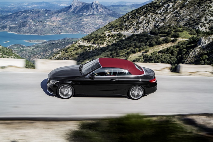 Black Mercedes-AMG C 43 Cabriolet driving on a mountain road