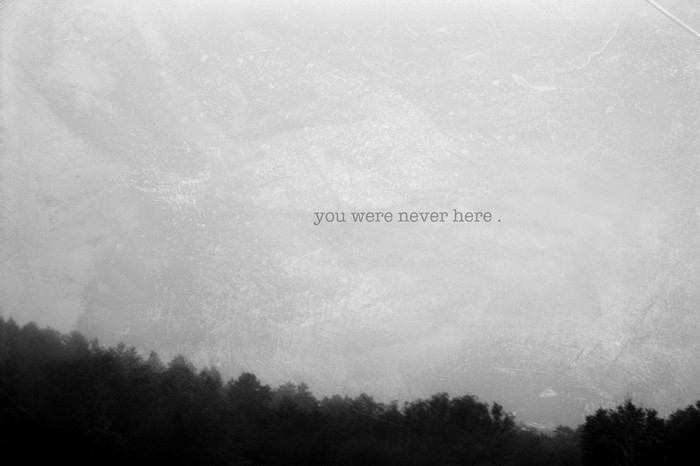 Monochrome forest silhouette with text overlay