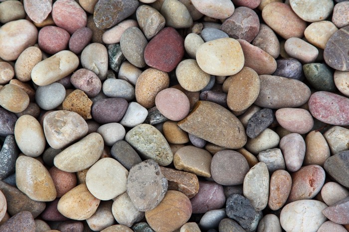 Close-up of various smooth river stones and pebbles