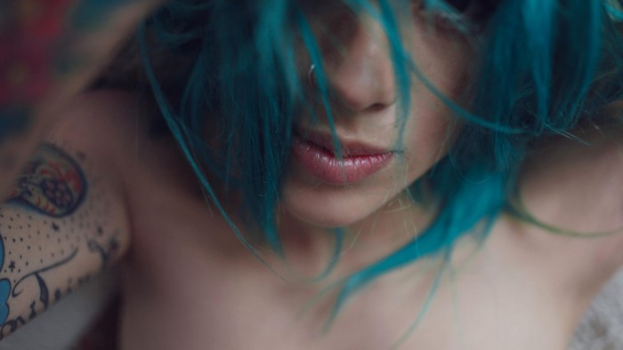 Woman with blue dyed hair and tattoos