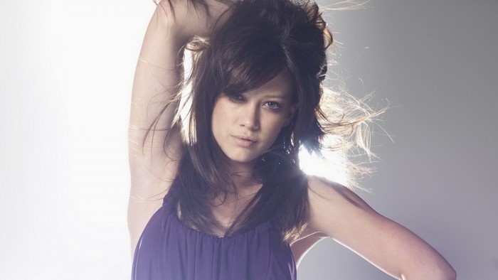 Hilary Duff posing with her hand in her hair