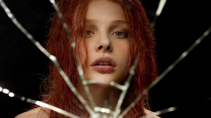 Chloe Grace Moretz behind broken glass
