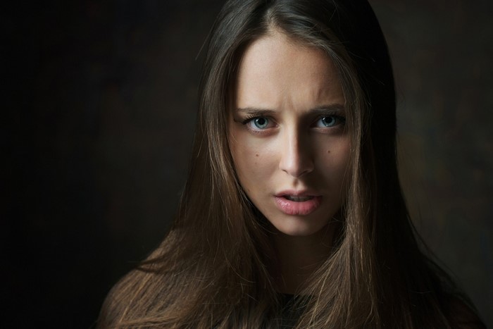 Portrait of Olesya Grimaylo with long brown hair and blue eyes