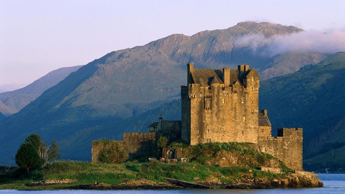 Eilean Donan Castle on a rocky island with mountains