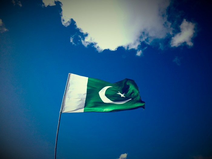 Pakistan Flag Waving Under Blue Sky