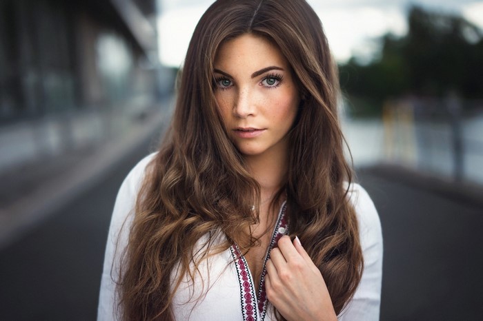 Woman with long brown hair and freckles