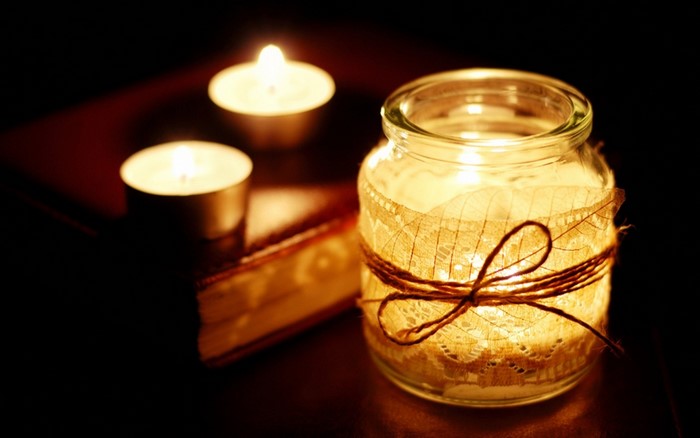 Candles in a jar and on a book