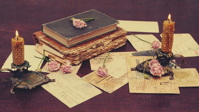 Vintage still life with books, letters, and candles