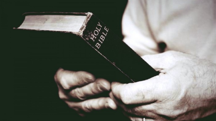Hands holding the Holy Bible