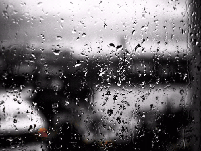 Raindrops on a window with blurred background