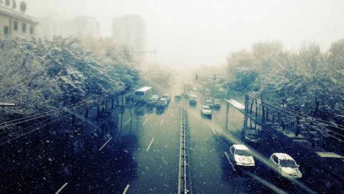 Cars driving on a snowy road in winter