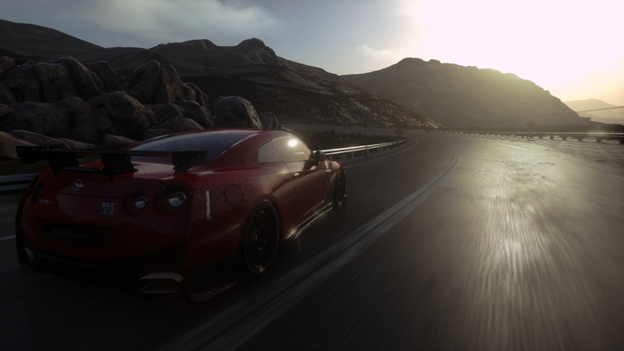 Red Nissan GT-R driving on a mountain road