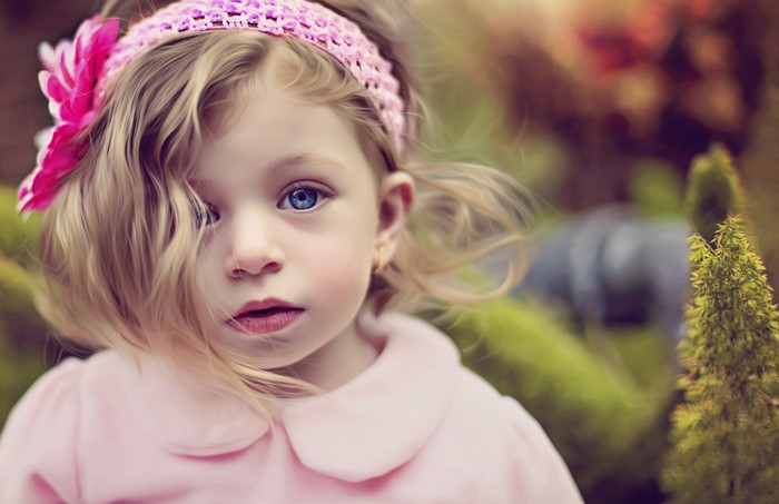 Portrait of a young girl with blue eyes and blonde hair