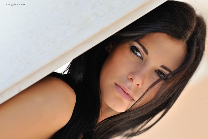 Woman with long dark hair and makeup