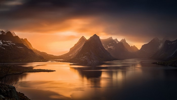 Mountains reflecting in water during sunset in Lofoten, Norway
