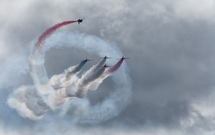 Air show with planes performing aerobatics with smoke trails