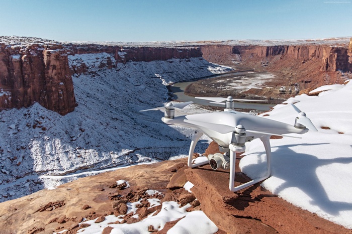 DJI Phantom 4 drone on snowy canyon cliff