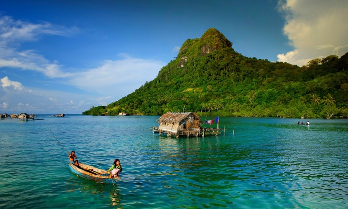 Tropical Bay with Traditional Boat and Lush Island